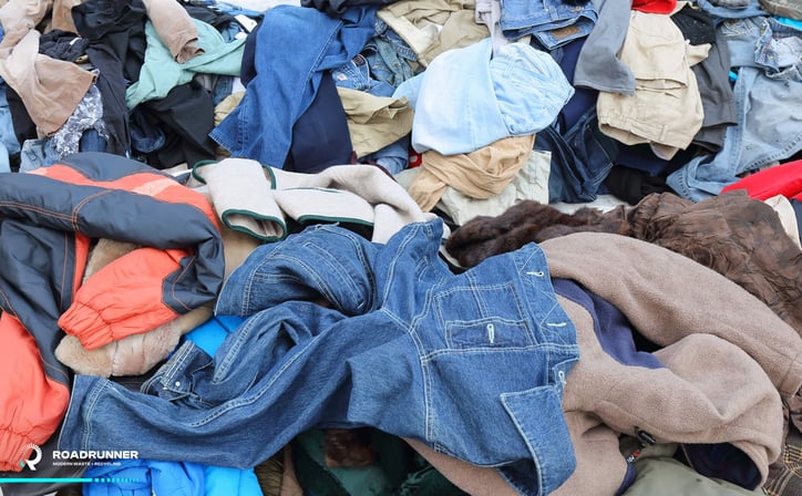 a pile of clothing in a landfill