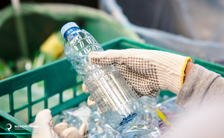 a worker sorts plastic recyclables