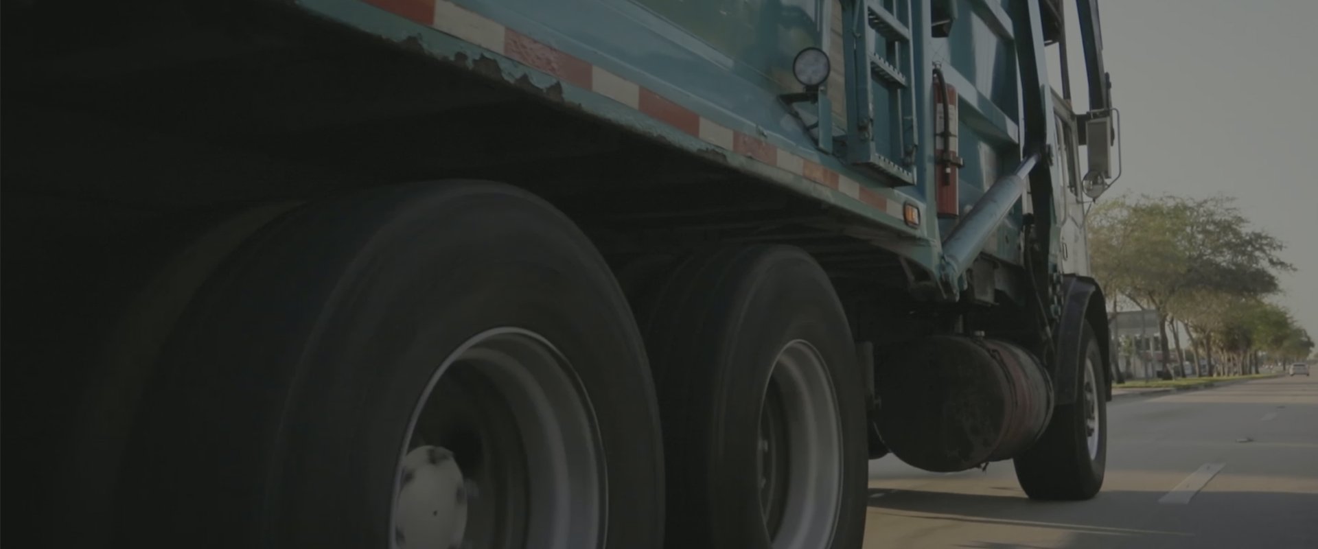 garbage truck driving on road